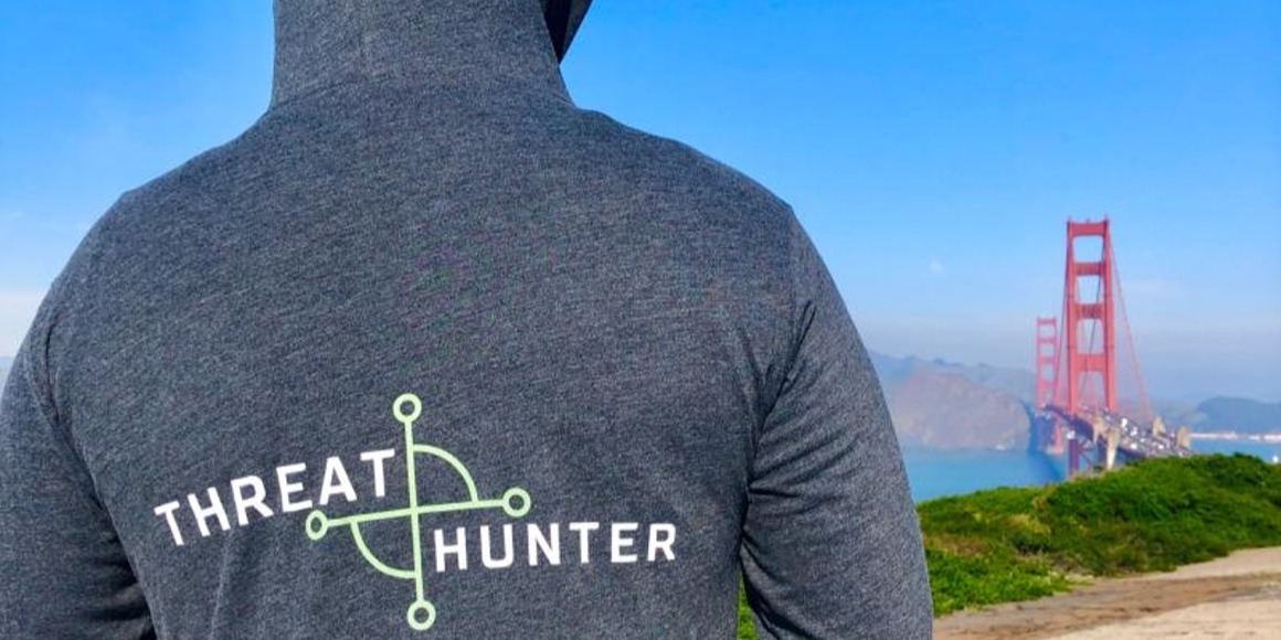 man wearing "threat hunter" sweatshirt looking at Golden Gate Bridge